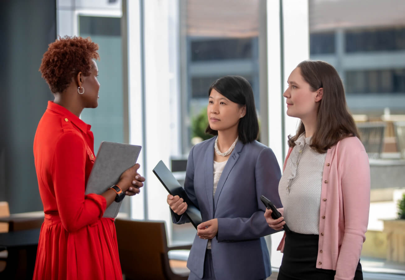Tara Favors, Jenny Lum and Erin Grainger meeting in an office at the Mutual of America Headquarters